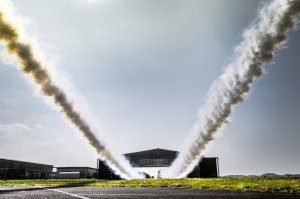 Paul Bonhomme and Steve Jones leave contrails after flying through a hangar during Red Bull Barnstorming photoshooting in Llandbedr, Wales, UK, on April the 09th, 2015